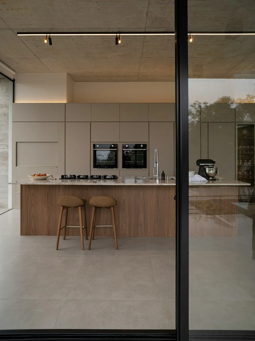 Fitted kitchen with an island and bar stools