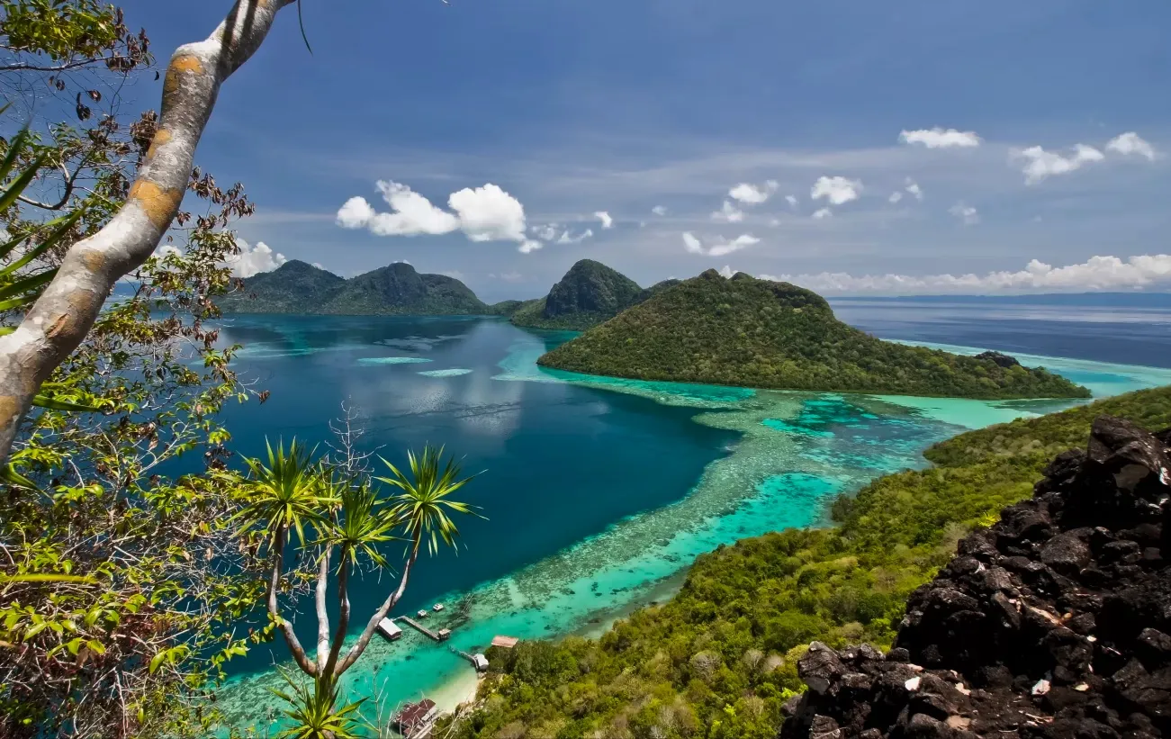 Turquoise bay and reef between forested islands